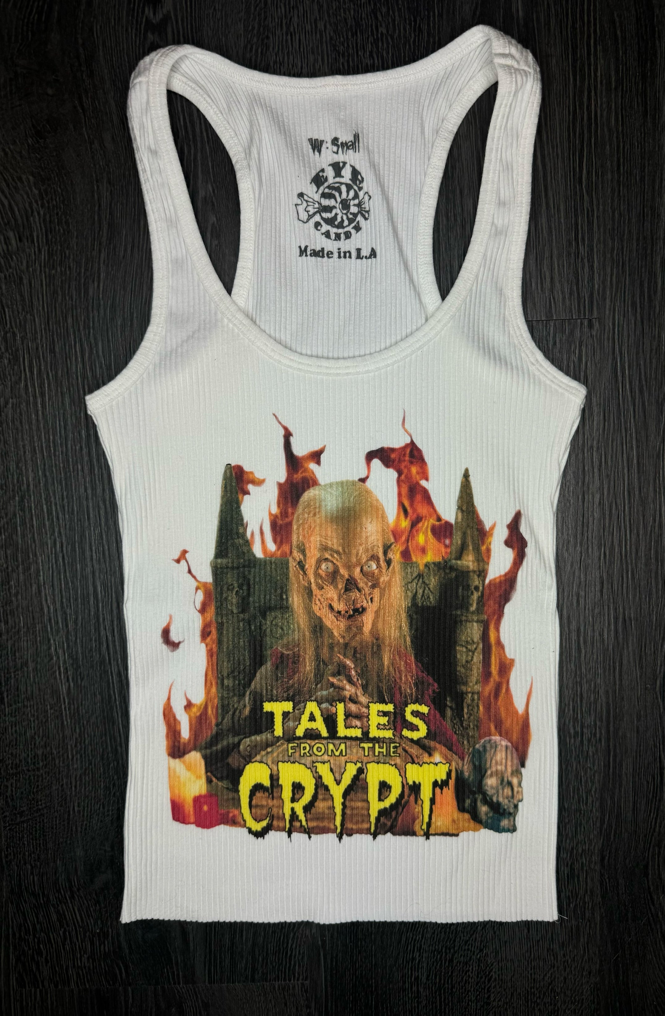 White tank top with 'Tales from the Crypt' graphic design on a dark background