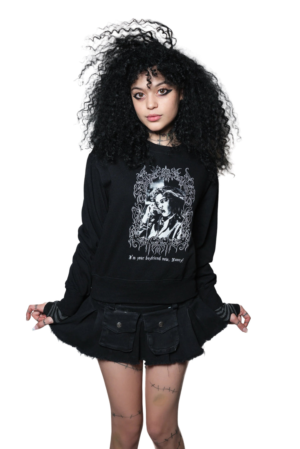 Person wearing a black sweatshirt with a graphic design on a white background