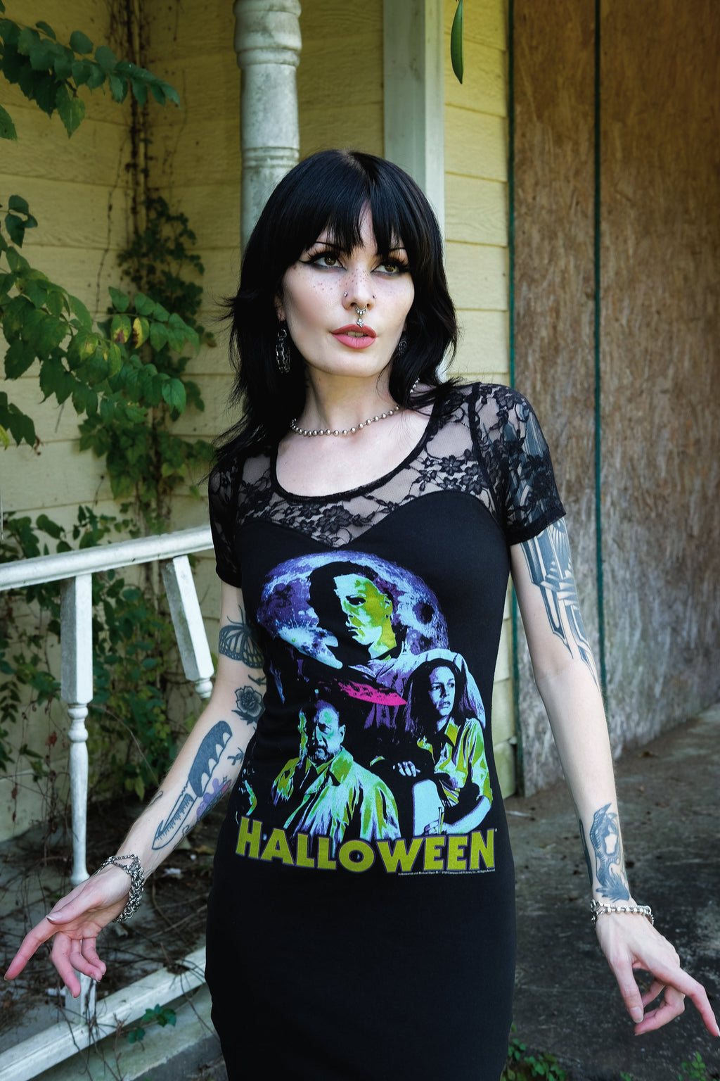 Person wearing a black t-shirt with a colorful graphic design and 'Halloween' text, standing outdoors.