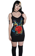 Woman wearing a black tank dress with a graphic design on a white background